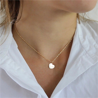 Heart-shaped porcelain necklace with gold Kintsugi (Kintsukuroi) accents, highlighting the beauty of mending and celebrating imperfections. Handmade kintsugi, kintsugi inspired. Gold veins on white porcelain handmade