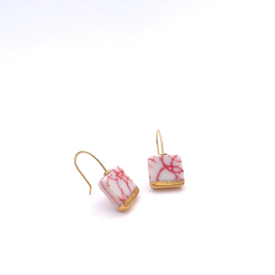 Square shaped dangle earrings in gold made out of ceramic porcelain