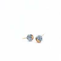 Handcrafted olive speckled porcelain earrings with 24K gold luster. Lightweight, durable, and inspired by Delft Blue tradition. A refined 18-year anniversary gift.