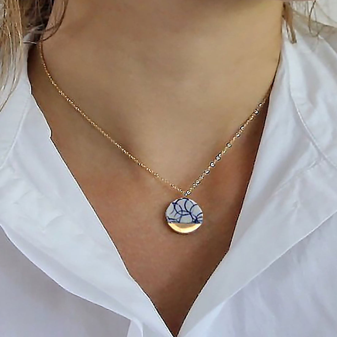 A blue and white porcelain pendant adorned with 24k gold on a delicate 14k gold filled chain, available in different lengths. This necklace is also available with matching earrings. A perfect porcelain anniversary gift jewelry set. 

Vintage porcelain jewelry, china blue jewelry, delft jewelry
Handmade by OeiCeramics
A ceramic workshop inspired by the Delft blue ware of the Dutch town of Delft. Delftsblauw